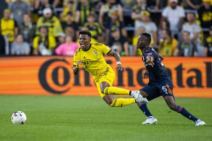 Jul 17, 2022; Columbus, Ohio, USA; Columbus Crew midfielder Luis Diaz (12) is fouled by FC Cincinnati midfielder Obinna Nwobodo (5) in the first half at Lower.com Field. Mandatory Credit: Trevor Ruszkowski-USA TODAY Sports