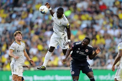 Jul 23, 2022; Columbus, Ohio, USA; Columbus Crew defender Jonathan Mensah (4) goes up for a header as New England Revolution forward Jozy Altidore (14) defends during the first half at Lower.com Field. Mandatory Credit: Joseph Maiorana-USA TODAY Sports