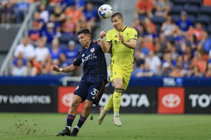 Jul 23, 2022; Cincinnati, Ohio, USA;  Nashville SC midfielder Alex Muyl (right) heads the ball against FC Cincinnati midfielder Alvaro Barreal (31) in the first half at TQL Stadium. Mandatory Credit: Aaron Doster-USA TODAY Sports