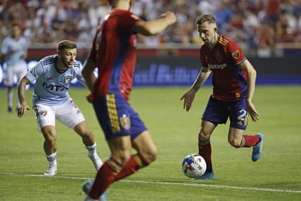 Jul 23, 2022; Sandy, Utah, USA; Real Salt Lake defender Andrew Brody (2) looks to pass to forward Justin Meram (9) against FC Dallas forward Paul Arriola (7) in the second half at Rio Tinto Stadium. Mandatory Credit: Jeffrey Swinger-USA TODAY Sports