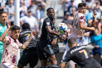 Jul 30, 2022; Saint Paul, Minnesota, USA; Portland Timbers midfielder David Ayala (24) and Minnesota United defender Bakaye Dibassy (12) watch as midfielder Franco Fragapane (7) heads the corner kick for a goal in the first half at Allianz Field. Mandatory Credit: Matt Blewett-USA TODAY Sports