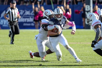 Oct 27, 2018; Provo, UT, USA; Brigham Young Cougars quarterback Zach Wilson (11) is tackled from behind by Northern Illinois Huskies linebacker Kyle Pugh (57) during the second half at LaVell Edwards Stadium. Northern Illinois Huskies won 7-6. Mandatory Credit: Chris Nicoll-USA TODAY Sports
