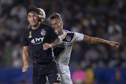 Sep 15, 2019; Carson, CA, USA; Sporting Kansas City midfielder Felipe Gutierrez (21) and LA Galaxy forward Ethan Zubak (29) battle for the ball during the first half at StubHub Center. Mandatory Credit: Kelvin Kuo-USA TODAY Sports