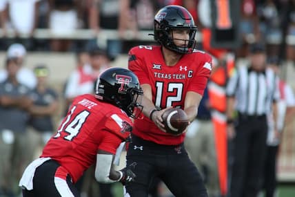 Sep 18, 2021; Lubbock, Texas, USA; Texas Tech Red Raiders quarter back Tyler Shough (12) hands off to running back Xavier White (14) against the Florida International Panthers during the first half at Jones AT&T Stadium. Mandatory Credit: Michael C. Johnson-USA TODAY Sports