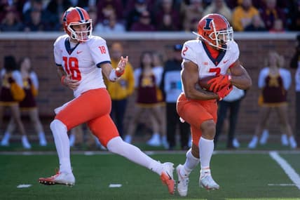 Nov 6, 2021; Minneapolis, Minnesota, USA; Illinois Fighting Illini quarterback Brandon Peters (18) passes the ball off to Illinois Fighting Illini running back Chase Brown (2) in the second quarter against the Minnesota Golden Gophers at Huntington Bank Stadium. Mandatory Credit: Matt Krohn-USA TODAY Sports