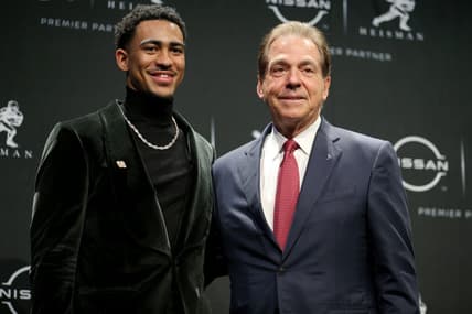 Dec 11, 2021; New York, NY, USA; 2021 Heisman winner Alabama quarterback Bryce Young (left) poses for pictures with head coach Nick Saban during a press conference at the New York Marriott Marquis in New York City. Mandatory Credit: Brad Penner-USA TODAY Sports