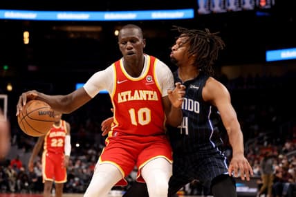 Dec 22, 2021; Atlanta, Georgia, USA; Atlanta Hawks center Gorgui Dieng (10) makes a move on Orlando Magic forward Freddie Gillespie (44) during the second quarter at State Farm Arena. Mandatory Credit: Jason Getz-USA TODAY Sports