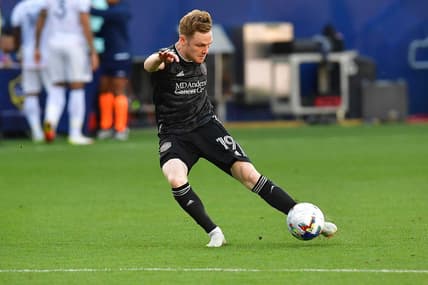 May 22, 2022; Carson, California, USA; Houston Dynamo forward Tyler Pasher (19) scores a goal against the Los Angeles Galaxy during the second half at Dignity Health Sports Park. Mandatory Credit: Gary A. Vasquez-USA TODAY Sports