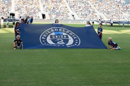 Jun 26, 2022; Philadelphia, Pennsylvania, USA; Young fans hold up the Philadelphia Union flag prior to the game against New York City FC at Subaru Park. Mandatory Credit: Gregory Fisher-USA TODAY Sports