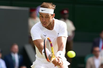 Jul 6, 2022; London, England, United Kingdom; Rafael Nadal (ESP) returns a shot during his quarter finals men   s singles match against Taylor Fritz (USA) on Centre court at All England Lawn Tennis and Croquet Club. Mandatory Credit: Peter van den Berg-USA TODAY Sports