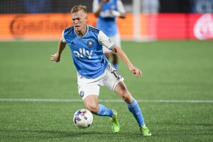 Jul 30, 2022; Charlotte, North Carolina, USA; Charlotte FC forward Karol Swiderski (11) brings the ball up field against the Columbus Crew during the first half at Bank of America Stadium. Mandatory Credit: Jim Dedmon-USA TODAY Sports