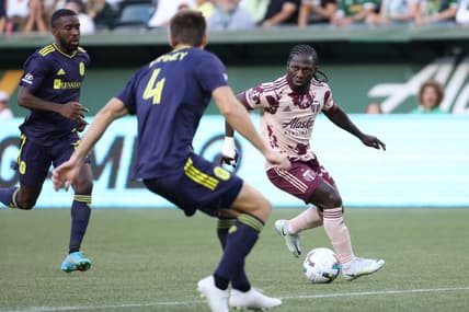 Aug 3, 2022; Portland, Oregon, USA; Portland Timbers forward Yimmi Chara (23) looks to passes the ball against Nashville SC defender Dave Romney (4) during the first half at Providence Park. Mandatory Credit: Jaime Valdez-USA TODAY Sports