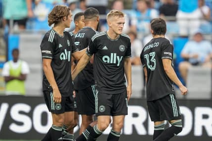 Aug 3, 2022; Charlotte, North Carolina, USA; Charlotte FC forward Karol Swiderski (11) gets congratulations on his first goal against the D.C. United from his teammates during the first half at Bank of America Stadium. Mandatory Credit: Jim Dedmon-USA TODAY Sports
