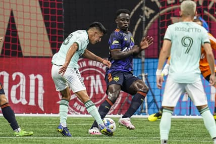 Aug 6, 2022; Atlanta, Georgia, USA; Atlanta United midfielder Thiago Almada (8) takes a shot against Seattle Sounders defender Yeimar Gomez (28) during the first half at Mercedes-Benz Stadium. Mandatory Credit: Dale Zanine-USA TODAY Sports