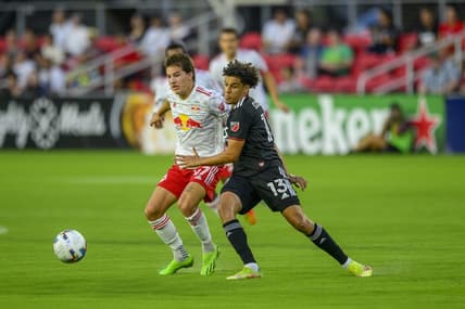 Aug 6, 2022; Washington, District of Columbia, USA; New York Red Bulls defender John Tolkin (47) battles D.C. United midfielder Sofiane Djeffal (13) for the ball at Audi Field. Mandatory Credit: Rafael Suanes-USA TODAY Sports