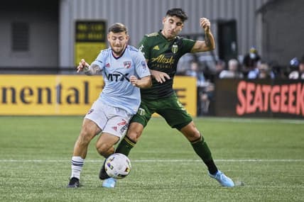 Aug 6, 2022; Portland, Oregon, USA; Portland Timbers defender Claudio Bravo (5) defends FC Dallas forward Paul Arriola (7) during the first half at Providence Park. Mandatory Credit: Troy Wayrynen-USA TODAY Sports