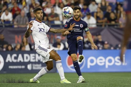 Aug 13, 2022; Foxborough, Massachusetts, USA; New England Revolution midfielder Carles Gil (10) passes the ball past D.C. United midfielder Victor Palsson (44) during the first half at Gillette Stadium. Mandatory Credit: Winslow Townson-USA TODAY Sports