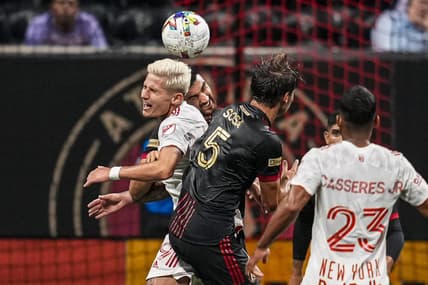 Aug 17, 2022; Atlanta, Georgia, USA; Atlanta United defender Juan Jose Purata (22) and New York Red Bulls forward Patryk Klimala (9) go for the ball during the first half at Mercedes-Benz Stadium. Mandatory Credit: Dale Zanine-USA TODAY Sports