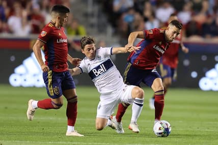 Aug 20, 2022; Sandy, Utah, USA; Vancouver Whitecaps FC midfielder Ryan Gauld (25) fights for a ball against Real Salt Lake defender Aaron Herrera (22) in the first half at Rio Tinto Stadium. Mandatory Credit: Rob Gray-USA TODAY Sports