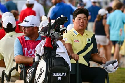 Aug 27, 2022; Atlanta, Georgia, USA; Sungjae Im and his caddie William Spencer ride back to the club house in a golf cart during a weather delay during the third round of the TOUR Championship golf tournament. Mandatory Credit: Adam Hagy-USA TODAY Sports