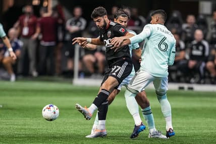 Aug 28, 2022; Atlanta, Georgia, USA; D.C. United defender Sami Guediri (97) plays the ball away from Atlanta United midfielder Santiago Sosa (5) and defender Alan Franco (6) during the first half at Mercedes-Benz Stadium. Mandatory Credit: Dale Zanine-USA TODAY Sports