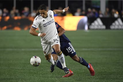 Aug 28, 2022; Foxborough, Massachusetts, USA; Los Angeles Galaxy forward Javier Hernandez (14) controls the ball while New England Revolution midfielder Brandon Bye (15) defends during the first half at Gillette Stadium. Mandatory Credit: Bob DeChiara-USA TODAY Sports