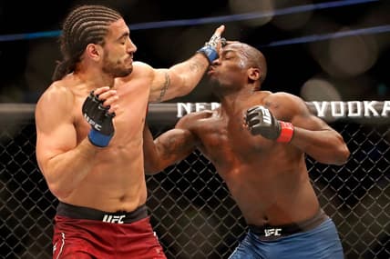 May 4, 2019; Ottawa, ON, Canada; Derek Brunson (red gloves) fights Elias Theodorou (blue gloves) during UFC Fight Night at Canadian Tire Centre. Mandatory Credit: Tom Szczerbowski-USA TODAY Sports