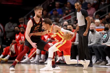 Feb 15, 2022; Atlanta, Georgia, USA; Atlanta Hawks guard Trae Young (11) makes a move against Cleveland Cavaliers forward Dean Wade (32) during the first quarter at State Farm Arena. Mandatory Credit: Jason Getz-USA TODAY Sports