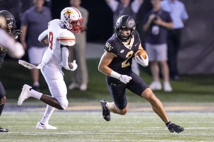 Sep 1, 2022; Winston-Salem, North Carolina, USA; Wake Forest Demon Deacons wide receiver Taylor Morin (2) runs around end chased by Virginia Military Institute Keydets wide receiver Julio DaSilva (9) during the first half at Truist Field. Mandatory Credit: Jim Dedmon-USA TODAY Sports