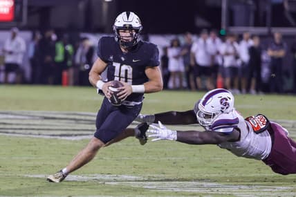Sep 1, 2022; Orlando, Florida, USA; UCF Knights quarterback John Rhys Plumlee (10) carries the ball as South Carolina State Bulldogs defensive lineman Jeblonski Green Jr. (34) moves in during the second half at FBC Mortgage Stadium. Mandatory Credit: Mike Watters-USA TODAY Sports