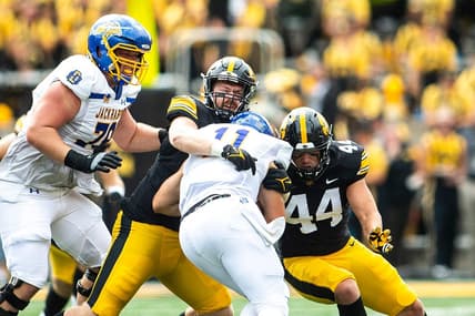 Iowa defensive lineman John Waggoner and linebacker Seth Benson (44) tackle South Dakota State quarterback Mark Gronowski during a NCAA football game, Saturday, Sept. 3, 2022, at Kinnick Stadium in Iowa City, Iowa.

220903 Sdsu Iowa Fb 025 Jpg