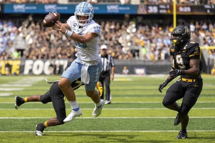 Sep 3, 2022; Boone, North Carolina, USA; North Carolina Tar Heels quarterback Drake Maye (10) dives into the end zone for the two point conversion attempt pursued by Appalachian State Mountaineers linebacker Nick Hampton (9) during the second half at Kidd Brewer Stadium. Mandatory Credit: Jim Dedmon-USA TODAY Sports