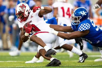 Sep 3, 2022; Lexington, Kentucky, USA; Miami (Oh) Redhawks running back Tyre Shelton (9) runs the ball against Kentucky Wildcats defensive lineman Tre'vonn Rybka (90) during the first quarter at Kroger Field. Mandatory Credit: Jordan Prather-USA TODAY Sports