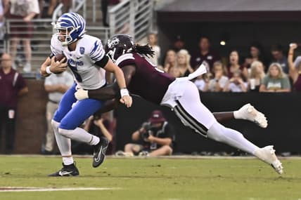 Sep 3, 2022; Starkville, Mississippi, USA; Memphis Tigers quarterback Seth Henigan (5) is sacked by Mississippi State Bulldogs defensive end Randy Charlton (5) during the first quarter at Davis Wade Stadium at Scott Field. Mandatory Credit: Matt Bush-USA TODAY Sports