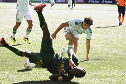 Sep 4, 2022; Portland, Oregon, USA;  Atlanta United midfielder Santiago Sosa (5) fouls Portland Timbers midfielder Diego Chara (21) during the second half setting up a penalty kick at Providence Park. The Timbers won 2-1. Mandatory Credit: Troy Wayrynen-USA TODAY Sports