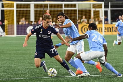 Sep 4, 2022; Foxborough, Massachusetts, USA; New England Revolution midfielder Noel Buck (29) defends the ball from New York City defender Tayvon Gray (24) during the first half at Gillette Stadium. Mandatory Credit: Eric Canha-USA TODAY Sports