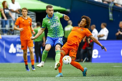 Sep 4, 2022; Seattle, Washington, USA; Seattle Sounders FC midfielder Albert Rusnak (11) and Houston Dynamo midfielder Adalberto Carrasquilla (20) collide in pursuit of a pass during the first half at Lumen Field. Mandatory Credit: Joe Nicholson-USA TODAY Sports