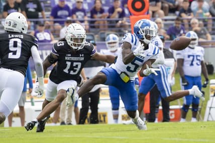 Sep 10, 2022; Evanston, Illinois, USA; Duke Blue Devils wide receiver Jalon Calhoun (5) receives a pass against Northwestern Wildcats defensive back Garnett Hollis Jr. (13) during the first quarter at Ryan Field. Mandatory Credit: Patrick Gorski-USA TODAY Sports