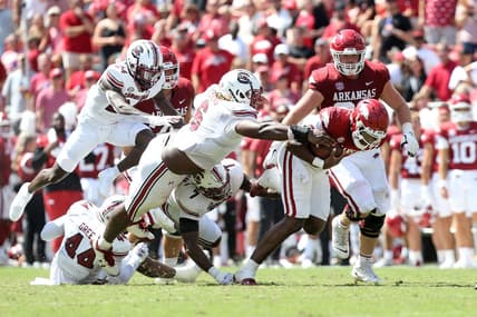 Sep 10, 2022; Fayetteville, Arkansas, USA; Arkansas Razorbacks quarterback KJ Jefferson (1) breaks several tackle attempts in the second quarter as South Carolina Gamecocks defensive lineman Zach Pickens (6) reaches for the ball at Donald W. Reynolds Razorback Stadium. Mandatory Credit: Nelson Chenault-USA TODAY Sports