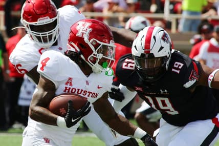 Sep 10, 2022; Lubbock, Texas, USA;  Houston Cougars running back Ta   Zawn Henry (4) rushes against Texas Tech Red Raiders defensive back Tyree Wilson (19) in the first half at Jones AT&T Stadium and Cody Campbell Field. Mandatory Credit: Michael C. Johnson-USA TODAY Sports