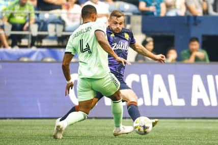 Sep 10, 2022; Seattle, Washington, USA; Austin FC defender Ruben Gabrielsen (4) clears the ball away from Seattle Sounders FC forward Jordan Morris (13) during the first half at Lumen Field. Mandatory Credit: Joe Nicholson-USA TODAY Sports