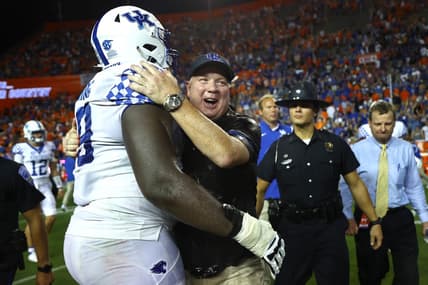 Sep 10, 2022; Gainesville, Florida, USA; Kentucky Wildcats head coach Mark Stoops and offensive lineman Tashawn Manning (79) celebrate after they beat the Florida Gators at Ben Hill Griffin Stadium. Mandatory Credit: Kim Klement-USA TODAY Sports