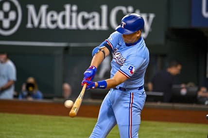 Sep 11, 2022; Arlington, Texas, USA; Texas Rangers first baseman Nathaniel Lowe (30) hits a single and drives in a run against the Toronto Blue Jays during the first inning at Globe Life Field. Mandatory Credit: Jerome Miron-USA TODAY Sports