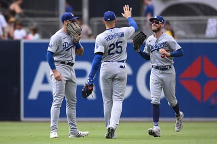 Sep 11, 2022; San Diego, California, USA; Los Angeles Dodgers right fielder Trayce Thompson (25) celebrates with center fielder Cody Bellinger (35) and left fielder Joey Gallo (12) after defeating the San Diego Padres at Petco Park. Mandatory Credit: Orlando Ramirez-USA TODAY Sports