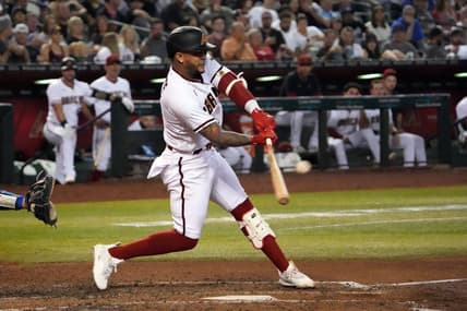Sep 12, 2022; Phoenix, Arizona, USA; Arizona Diamondbacks second baseman Ketel Marte (4) hits a double against the Los Angeles Dodgers during the sixth inning at Chase Field. Mandatory Credit: Joe Camporeale-USA TODAY Sports