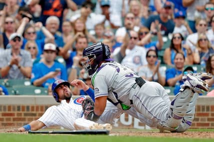 Sep 17, 2022; Chicago, Illinois, USA; Colorado Rockies catcher Elias Diaz (35) tags out Chicago Cubs first baseman Alfonso Rivas (36) at home during the fifth inning at Wrigley Field. Mandatory Credit: Jon Durr-USA TODAY Sports