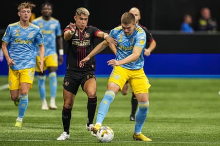 Sep 17, 2022; Atlanta, Georgia, USA; Atlanta United midfielder Luiz Ara  jo (19) tries to prevent Philadelphia Union forward Mikael Uhre (7) from advancing the ball during the first half at Mercedes-Benz Stadium. Mandatory Credit: Dale Zanine-USA TODAY Sports