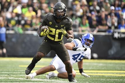 Sep 17, 2022; Eugene, Oregon, USA; Oregon Ducks running back Jordan James (20) breaks away from Brigham Young Cougars defensive lineman Pepe Tanuvasa (45) during the first half for a first down at Autzen Stadium. Mandatory Credit: Troy Wayrynen-USA TODAY Sports