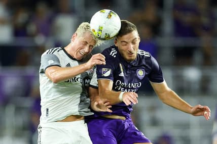 Sep 17, 2022; Orlando, Florida, USA;  Orlando City forward Ercan Kara (9) and Toronto FC defender Lukas MacNaughton (5) head the ball in the first half at Exploria Stadium. Mandatory Credit: Nathan Ray Seebeck-USA TODAY Sports