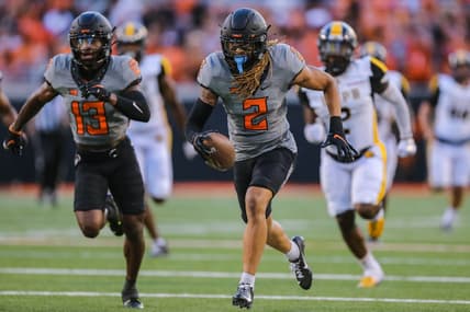 Sep 17, 2022; Stillwater, Oklahoma, USA; Oklahoma State Cowboys cornerback Korie Black (2) picks up a blocked kick and returns it for a touchdown against the Arkansas-Pine Bluff Golden Lions in the first half at Boone Pickens Stadium. Mandatory Credit: Nathan J. Fish-USA TODAY Sports